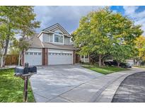 Charming two-story home with a three-car garage, brick accents, a large yard, and mature trees at 13723 Milwaukee Ct, Thornton, CO 80602