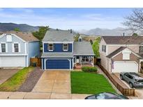 Charming two-story home with a well-manicured lawn and mountain views at 7927 Elmwood St, Littleton, CO 80125