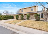 Inviting two-story home featuring brick accents, a well-maintained yard, and an attached two-car garage at 8610 E Eastman Ave, Denver, CO 80231