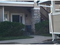 A charming home exterior featuring a stone pillar and lush green landscaping at 4054 S Carson St # 102, Aurora, CO 80014