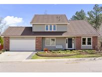 Charming two-story home featuring brick accents, a well-manicured lawn, and a large two-car garage at 7470 S Steele Cir, Centennial, CO 80122