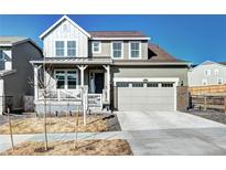 Charming two-story home with a two-car garage and welcoming front porch at 13437 Starhawk Ln, Parker, CO 80134