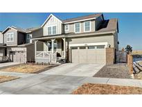 Charming two-story home features a covered front porch and attached two-car garage at 13437 Starhawk Ln, Parker, CO 80134