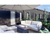 Relaxing patio area featuring a modern couch and ample seating space at 115 W 2Nd Ave # 101, Denver, CO 80223