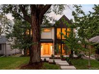 Charming two-story home with black and white exterior, large windows, and landscaped front yard at 1117 S Madison St, Denver, CO 80210