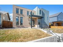 Modern home featuring a light brick facade, sleek lines, and a well-manicured lawn at 4351 Yates St, Denver, CO 80212