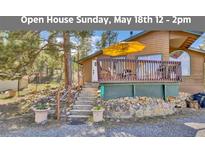 Charming exterior of home with inviting deck and landscaped yard at 11798 Ridge Rd, Golden, CO 80403