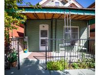 Charming front porch with decorative iron railing and seating area, perfect for relaxing outdoors at 3732 N Franklin St, Denver, CO 80205