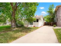 Charming single-Gathering home featuring a large tree and long driveway on a sunny day at 1160 S Steele St, Denver, CO 80210