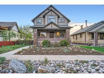 Charming two-story brick home with a landscaped yard and inviting front entrance at 2039 S Corona St, Denver, CO 80210