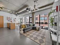 Bright living room features an open floor plan and expansive windows offering lots of natural light at 2100 16Th St # 204, Denver, CO 80202