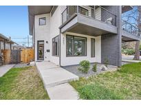 Contemporary home with a modern exterior, balcony, and manicured landscaping at 4457 Wyandot St, Denver, CO 80211