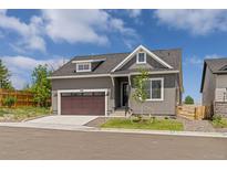 Charming single-Gathering home featuring a brown garage door, a well-maintained lawn, and beautiful exterior paint at 5909 S Platte Canyon Dr, Littleton, CO 80123