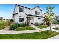 Charming two-story home featuring a well-manicured lawn and tasteful landscaping at 10254 Worchester St, Commerce City, CO 80022