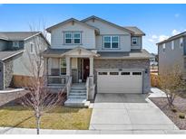 Charming two-story home featuring stone accents, a two-car garage, and a welcoming front porch at 24432 E Tennessee Pl, Aurora, CO 80018