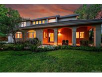 Stunning home exterior featuring an arched porch, manicured lawn, and vibrant landscaping at 2558 Premier Pl, Boulder, CO 80304