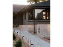 Charming home exterior showcases a well-manicured front yard and modern architectural details at 199 S Ivy St, Denver, CO 80224