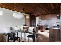 Modern kitchen with light floors, wood cabinets, stainless steel appliances and breakfast nook at 199 S Ivy St, Denver, CO 80224