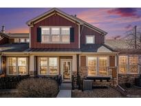 Beautiful townhome featuring stone accents, neutral-colored siding, black shutters, and a well-manicured front yard at 3751 W 136Th Ave # S3, Broomfield, CO 80023