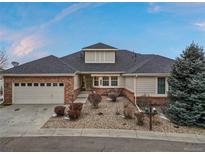 Charming ranch-style home featuring a brick facade, attached garage, and landscaped front yard at 7560 S Biloxi Ct, Aurora, CO 80016