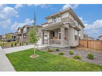 Charming two-story home featuring stone accents, a cozy front porch, and well-maintained landscaping at 14818 Dahlia St, Thornton, CO 80602