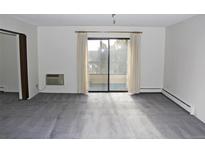 Bright living room with balcony access and carpet flooring at 13952 E Marina Dr # 304, Aurora, CO 80014
