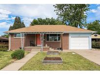 Charming brick home with a well-maintained front yard and covered porch at 1666 S Bryant St, Denver, CO 80219