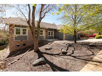 Charming single-story home with manicured front yard featuring mature trees and attractive rock landscaping at 6668 Fairways Dr, Longmont, CO 80503
