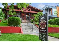 Charming brick home with eye-catching curb appeal and professional real estate signage at 2131 Eliot St, Denver, CO 80211
