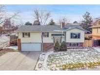 Ranch style home with attached garage and landscaped yard at 1927 S Xenon St, Lakewood, CO 80228