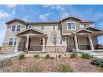 Attractive townhome featuring stone accents, covered porch, and low maintenance landscaping at 7265 S Millbrook Ct, Aurora, CO 80016