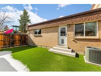 This home boasts a brick exterior and artificial turf in the backyard, great for low-maintenance living at 12893 W Alameda Dr, Lakewood, CO 80228