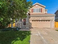 Charming two-story home featuring brick accents, red shutters, and a well-maintained lawn at 18554 E Vassar Dr, Aurora, CO 80013