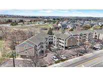 A building with multiple levels and balconies overlooks a road with mountains in the distance at 1263 S Gilbert St, Castle Rock, CO 80104