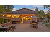 Backyard patio features stylish outdoor seating, dining area and bistro lights for a relaxing atmosphere at 10694 E Dorado Ave, Englewood, CO 80111