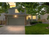 Charming two-story home with an attached garage and well-manicured lawn at 10535 Holyoke Dr, Parker, CO 80134