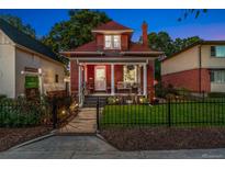 Charming two-story brick home featuring a cozy front porch and well-manicured lawn at 3016 N Franklin St, Denver, CO 80205