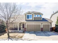 Two-story home with a three-car garage, brick accents, and neutral siding at 1280 Galactic Pl, Castle Rock, CO 80108