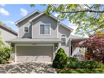 Charming two-story home featuring a well-manicured front yard and an attached two-car garage in a suburban neighborhood at 16225 Peregrine Dr, Parker, CO 80134