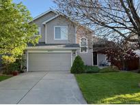 Charming two-story home with well-manicured lawn and a two-car garage at 16225 Peregrine Dr, Parker, CO 80134