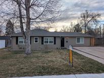 Charming single-story home with a well-maintained lawn and a paved driveway at 6528 S Louthan St, Littleton, CO 80120