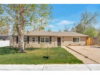 Charming one-story home featuring a well-manicured lawn and neutral siding at 6528 S Louthan St, Littleton, CO 80120
