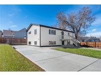 Charming home with a large driveway, manicured lawn, and a well-maintained white exterior at 111 Wolff St, Denver, CO 80219