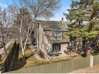A charming backyard with a patio, lush lawn, and privacy fence, perfect for relaxing and entertaining outdoors at 3471 S Ammons St # 12-6, Lakewood, CO 80227