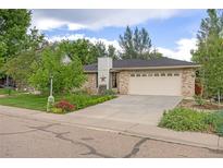 Charming single-Gathering home with a well-manicured lawn, mature trees, and an attached two-car garage at 2871 Humboldt Cir, Longmont, CO 80503