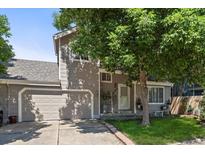 Charming two-story home with a well-maintained front yard, an attached garage, and mature shade trees at 8060 Meadowdale Sq, Niwot, CO 80503