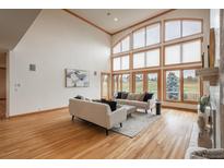 Bright living room with high ceilings, large windows, hardwood floors, and modern neutral furniture at 101 Glenmoor Ln, Cherry Hills Village, CO 80113