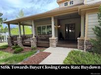 Inviting covered front porch with stone accents and ample space for relaxing at 1366 Killington Ct, Evergreen, CO 80439