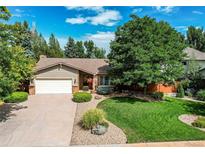 Charming single-story home with a well-manicured lawn and mature landscaping at 20855 E Lyttle Dr, Parker, CO 80138