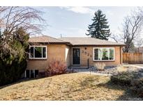 Charming brick home featuring a well-manicured lawn and mature landscaping at 3520 Miller St, Wheat Ridge, CO 80033